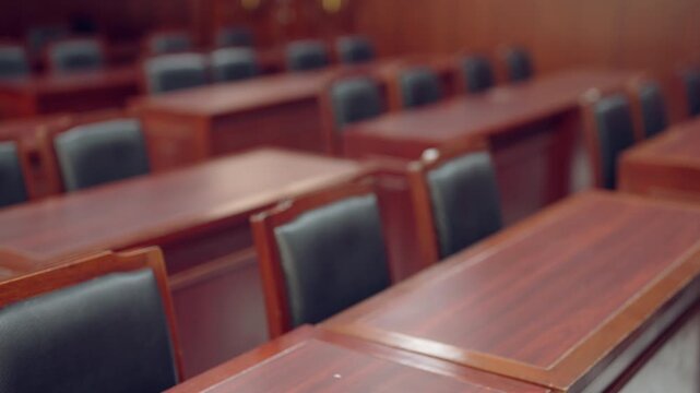 Empty courtroom interior with wooden seats representing justice system and legal proceedings. Concept of law, court environment, and judicial process in professional setting.