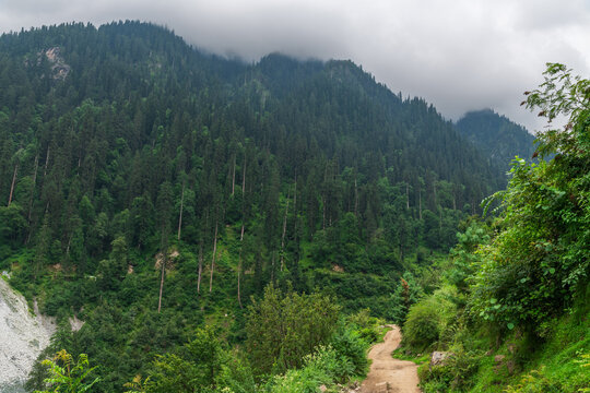 Mountain village road in Shilha village, Himalayan valley with dramatic landscape Himachal Pradesh India