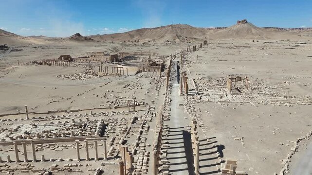 Cinematic aerial shot of the world-famous ruins of Palmyra, Syria, showcasing ancient Roman stone architecture