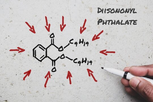 Chemical structure of Diisononyl Phthalate DINP on the wall background. DiNP known for flexibility and durability used as a plasticizer to make PVC, inflatable toys, food packaging etc. 
