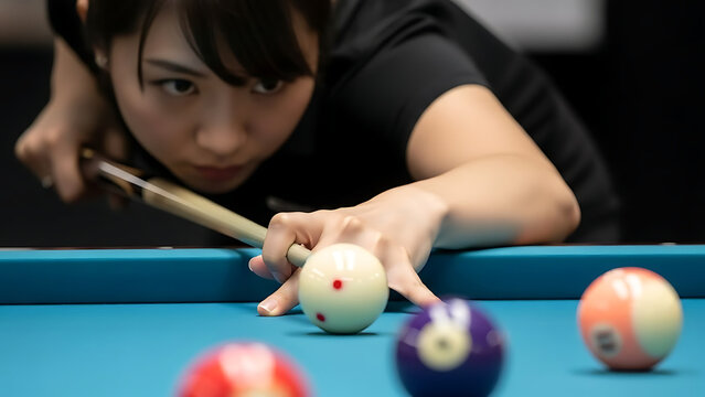 Woman playing billiards aiming at cue ball on pool table with focus