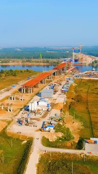 Vertical video. Murom, Russia. Construction of a bridge across the Oka River. Highway M-12 Moscow-Nizhny-Novgorod-Kazan. Drone footage. Rich colors