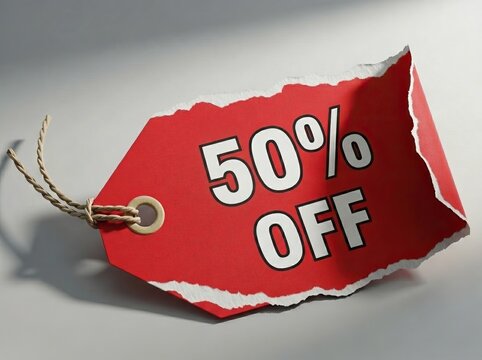 Red discount tag with torn edges displaying 50% off text, featuring a twine loop for attachment on a light background