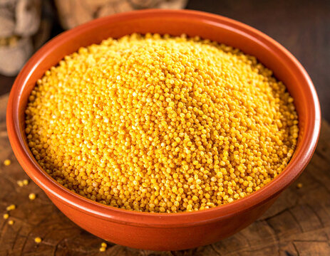 A vibrant bowl of raw fonio grains, ready for cooking a traditional Bissau-Guinean meal.
