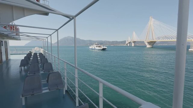 Side deck seats with sea view and ro ro ferry under bridge scene