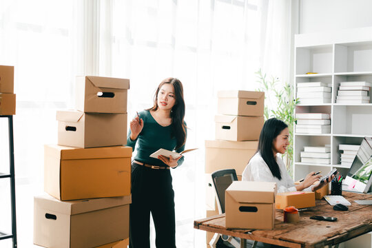 Small and medium-sized enterprise (SME) business owners are checking inventory, packing goods, and preparing for shipment.
