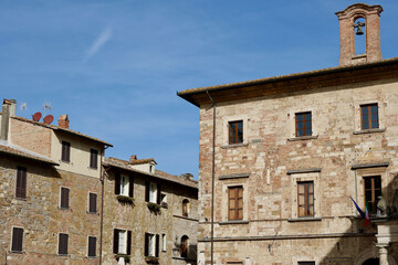 Fototapeta premium Historic Stone Buildings Under Blue Sky in Montepulciano, Tuscany, Italy