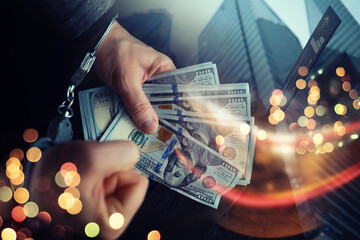  Double exposure city and hands of a man with handcuffs on a background of us dollars. Fraud, cyber crime concept. Arrest of an entrepreneur in the workplace.