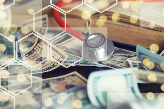 Close up red stethoscope on the US dollar banknote on wooden table. Health check or money and financial concept