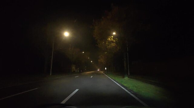 Car POV Driving on an Empty, Street-Lit Suburban Road at Night