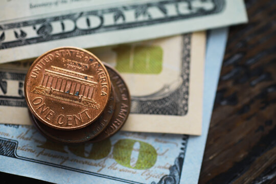 Close-up of US Penny Coin and Dollar Bills: Financial Concept, Currency, Banking, Economics