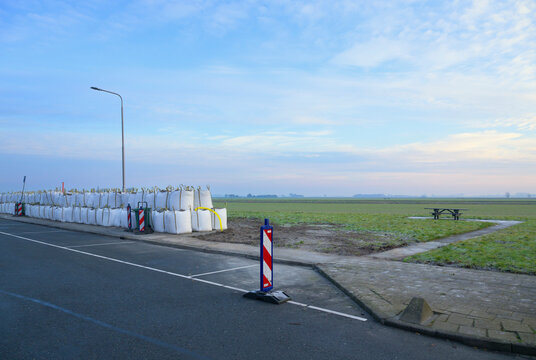 Sand bags for soil strengthening on empty parking lot in Benningbroek