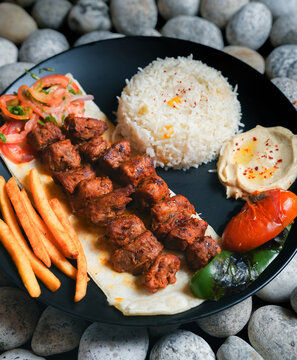 kebab, Chelo Kabab, shishkabob, home-cooked on the grill fire meat beef shish kebab with vegetables, grilled meat skewers, grilled tomatoes and peppers