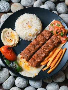 kebab, Chelo Kabab, shishkabob, home-cooked on the grill fire meat beef shish kebab with vegetables, grilled meat skewers, grilled tomatoes and peppers