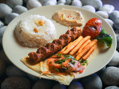 kebab, Chelo Kabab, shishkabob, home-cooked on the grill fire meat beef shish kebab with vegetables, grilled meat skewers, grilled tomatoes and peppers