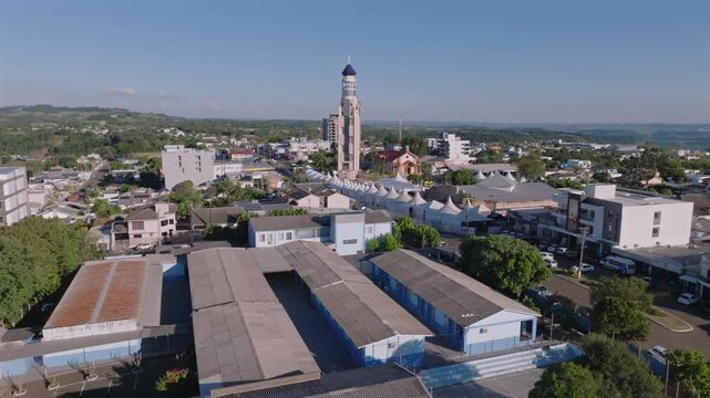 Town center rises into view as the drone ascends over Ametista do Sul, revealing the church tower and surrounding hills, captured in D-Log with 10-bit color using a Hasselblad sensor.