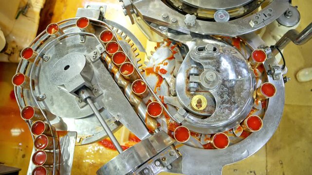 The sauce filling point into cans is one step in the process and production line of a canned fish factory
