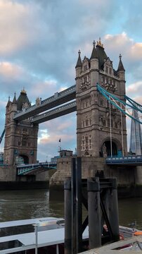 Tower Bridge at sunset over River Thames London - Iconic Victorian bascule structure with skyline and cloudy evening sky reflected in water urban landmark travel destination