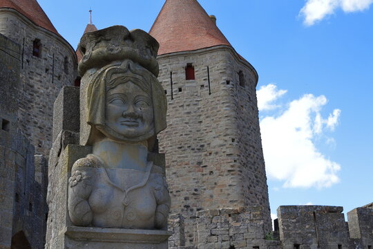 A replica of Lady Carcas's bust welcomes visitors of Carcassonne's historic fortress.