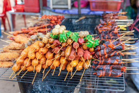 Roasted  skewers on a grill in a colorful local market, khmer street food near Siem Reap, Cambodia