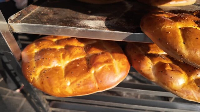 Close up view of fresh baked ramadan pide breads in bakery shelf under daylight.