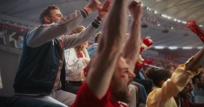 Diverse Fans in a Stadium Erupt in Cheer During a Soccer Championship Event, Backing Their Team in a Professional Sport Arena as a Dramatic Goal Sparks Applause, Smiles, and Celebration.