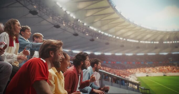 Diverse Fans in a Stadium Scream With Joy at a Soccer Championship Event, Their Team Won in a Professional Sport Aren.  Goal Lands and Supporters Cheer, Clap, Celebrate Together. Static Side Shot