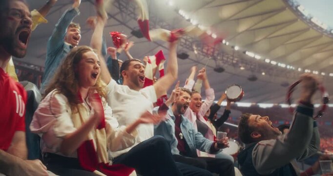 Diverse Fans in Big Stadium Cheer and Celebrate During a Soccer Championship Event, Backing Their Team in a Professional Arena as a Dramatic Goal Sparks Joy at an World League Cup Match