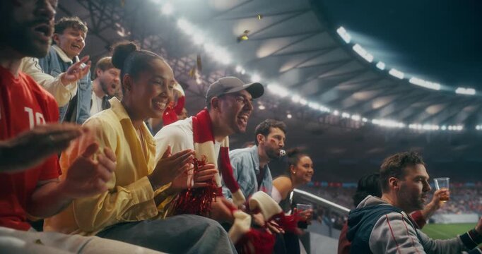 Portrait of Happy Multicultural Soccer Fans Cheering and Applauding in a Packed Night Stadium During a Professional International League Match, Celebrating a World Sports Event. Slow Motion.