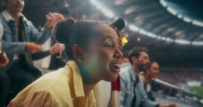Portrait of a Happy Black Female Soccer Fan Smiling, Cheering and Celebrating With Fellow Supporters in a Packed Stadium During a Professional International League World Event, Slow Motion.