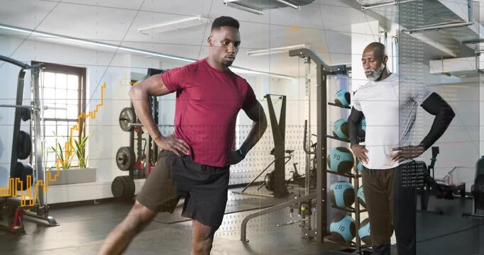 Trainer stepping in and cueing trainee performing red band lateral swings in gym for balance