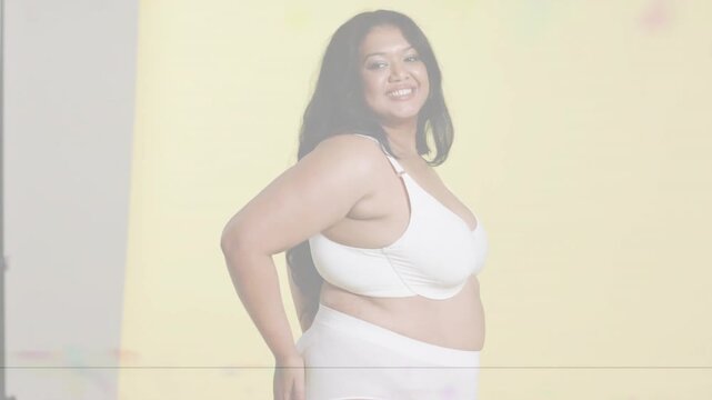 Model shifting poses after camera cue for fashion on yellow backdrop, scanlines crossing frame