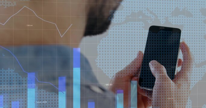 Tapping smartphone with right thumb, man in blue shirt at desk displaying bar chart, line graph
