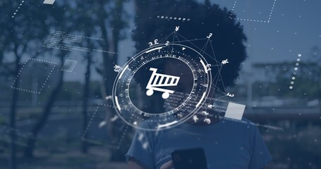 Holding smartphone, woman wearing short-sleeve tee standing on park path with shopping cart HUD