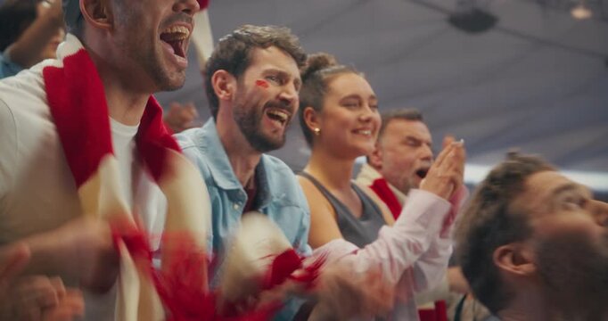 Portrait of Happy Soccer Fans Cheering and Clapping in a Packed Stadium During a Professional International World Game League Match, Diverse Supporters Celebrating. Cinematic Zoom in Shot.