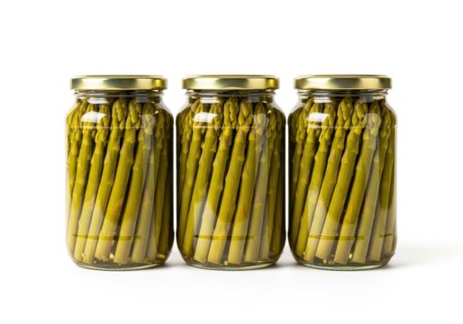 Three glass jars filled with pickled asparagus spears isolated on white background