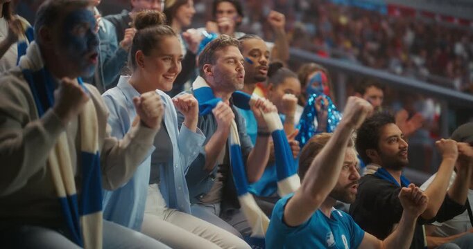 Close-up of Diverse Soccer Supporters Celebrating in a Packed stadium Smiling, Chanting and Raising Arms for Their Team During a Professional League Match and Major International Tournament.