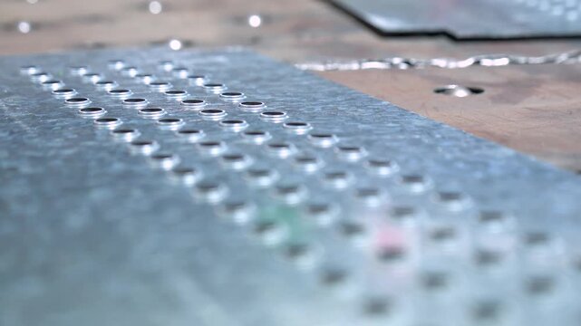 Perforated Steel Cut And Fabricated In A Industrial Metalworking Plant By A Hydraulic Press Punch.