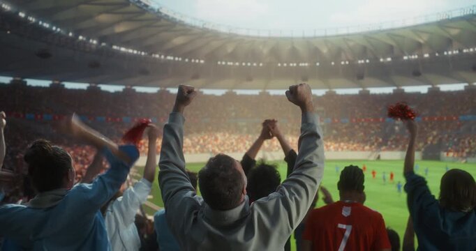 Back View of Diverse Soccer Fans in a Full Stadium Celebrating a Professional International Championship Match, Raising hands and Victory Props While Players Compete Field
