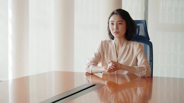 Focused young female manager ceo leader having work meeting in the boardroom, instructing staff on tasks, discussing project instructing staff on tasks, explaining financial plan strategies to staff