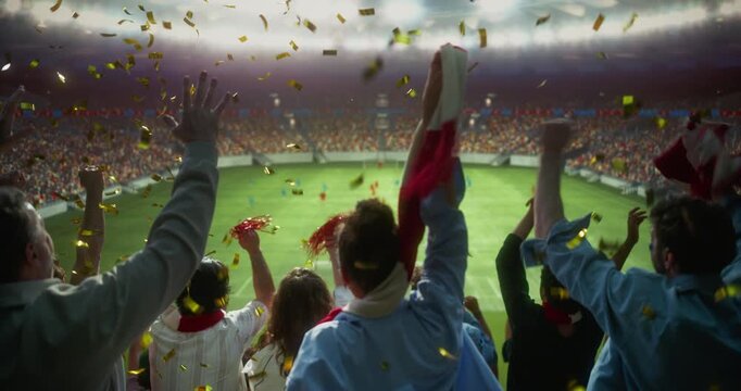 Rear View of Diverse Soccer Supporters in a Packed Stadium Celebrating a Professional International Championship Match, Waving Scarves and Victory Props, Clapping and Lifting Arms as Confetti Falls