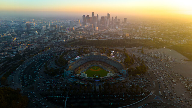 Aerial view of Dodger Stadium bathed in golden light with the downtown skyline in the distance, Los Angeles, California, United States.