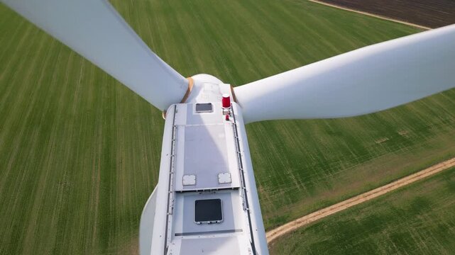 Aerial Close-up of Wind Turbine Nacelle and Blades Over Green Fields