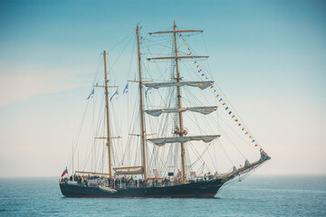 Large sailing vessel with people, tall Ship Sailing On Calm Sea With Colorful Signal Flags And Crowded Deck Black Sea Varna, Bulgaria © ValentinValkov