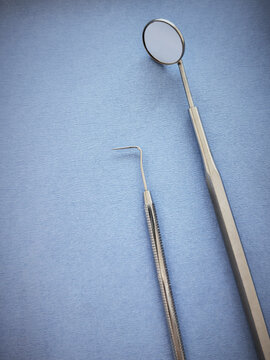 Close up of dental instruments on a blue background
