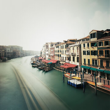 Historic buildings and gondolas along Venetian canal, Venice, Italy
