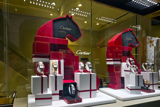 Bologna, Italy, January 3, 2026: Luxurious Cartier Watch Display in Equestrian-Themed Storefront for Holiday Shopping