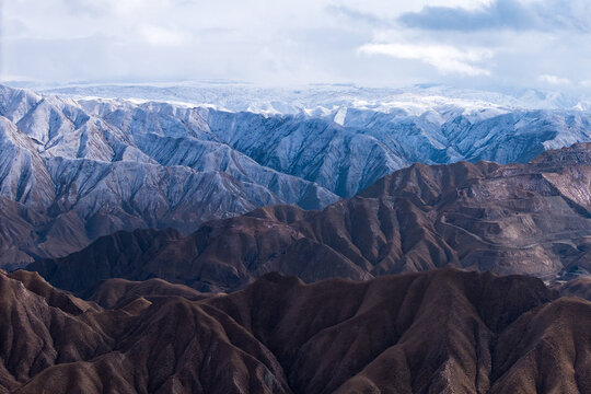 Snow covered Qilian Mountains featuring dramatic Danxia landforms in China
