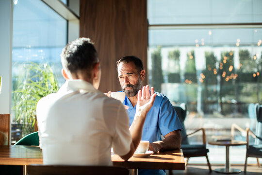 Healthcare worker meeting a colleague over coffee in a modern cafe