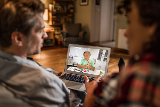 Couple having online video consultation with doctor at home